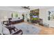 Comfortable living room with stone fireplace, wood floors, and lots of natural light at 9136 Ladson Rd, Indian Land, SC 29707