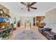 Open living room with a stone fireplace, wood floors, and natural light, creating a warm and inviting atmosphere at 9136 Ladson Rd, Indian Land, SC 29707