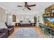 Bright living room features a stone fireplace, wood floors, and cozy leather furniture at 9136 Ladson Rd, Indian Land, SC 29707