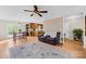 Bright living room featuring wood floors, a comfortable couch, and access to the kitchen and dining area at 9136 Ladson Rd, Indian Land, SC 29707