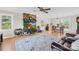 Cozy living room with stone fireplace, wood floors, and a view of the outdoors, ideal for relaxing and entertaining at 9136 Ladson Rd, Indian Land, SC 29707