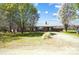 Quaint one-story brick home featuring mature shade trees and a metal roof at 976 Pointview Ln, Lincolnton, NC 28092