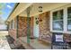 Inviting covered porch area with a brick wall and decorative iron supports at 976 Pointview Ln, Lincolnton, NC 28092