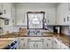 Kitchen sink with window, white cabinets and wood countertops at 976 Pointview Ln, Lincolnton, NC 28092