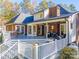 Spacious multi-tiered back deck featuring outdoor seating, a grill, and beautiful landscaping at 10032 Hunters Trace Dr, Concord, NC 28027