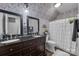 Charming bathroom featuring double vanity, floral wallpaper, and a shower-tub combination at 10032 Hunters Trace Dr, Concord, NC 28027