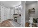 This primary bathroom features dual sinks, a water closet, and decorative shelving at 10032 Hunters Trace Dr, Concord, NC 28027