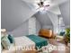 Attic bedroom featuring hardwood floors, a ceiling fan, neutral paint, and a comfortable chair at 10032 Hunters Trace Dr, Concord, NC 28027