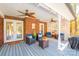 Covered patio featuring outdoor seating, brick columns, ceiling fans, and decorative fall accents at 10032 Hunters Trace Dr, Concord, NC 28027