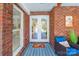 Charming entryway with brick facade, a cozy chair, and double doors that offer a warm welcome at 10032 Hunters Trace Dr, Concord, NC 28027