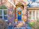 Close-up of a beautifully decorated front door with a festive fall wreath and planters at 10032 Hunters Trace Dr, Concord, NC 28027