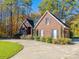 Charming brick home with well-maintained landscaping, mature trees and a circular driveway at 10032 Hunters Trace Dr, Concord, NC 28027