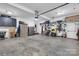 Well-lit two-car garage featuring abundant tool storage and a sturdy concrete floor at 10032 Hunters Trace Dr, Concord, NC 28027