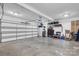 Spacious two-car garage with an automatic door and ample storage space at 10032 Hunters Trace Dr, Concord, NC 28027