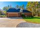 Spacious brick home with a two-car garage and well-manicured lawn exudes curb appeal at 10032 Hunters Trace Dr, Concord, NC 28027