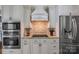 Well-appointed kitchen with custom cabinetry, granite counters, stainless appliances, and designer backsplash at 10032 Hunters Trace Dr, Concord, NC 28027