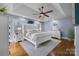 Spacious main bedroom with a tray ceiling, hardwood floors, and serene decor at 10032 Hunters Trace Dr, Concord, NC 28027