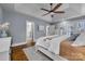 Comfortable main bedroom with natural light, hardwood floors, and a view to the ensuite bathroom at 10032 Hunters Trace Dr, Concord, NC 28027