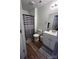 Well-lit bathroom with modern sink, toilet, striped shower curtain, and stylish decor at 102 Guffey Rd, Cherryville, NC 28021