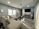 Cozy living room with neutral decor, large window for natural light, and comfortable seating at 102 Guffey Rd, Cherryville, NC 28021