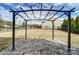 Backyard with a stone-paved patio featuring pergola and string lights at 11203 Chapeclane Rd, Charlotte, NC 28278
