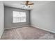 Bedroom featuring plush carpet, a window, and overhead lighting at 11203 Chapeclane Rd, Charlotte, NC 28278