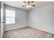 Bright bedroom features soft carpet, natural light and overhead fan at 11203 Chapeclane Rd, Charlotte, NC 28278