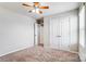 Bedroom featuring plush carpet, a window, and a double door closet at 11203 Chapeclane Rd, Charlotte, NC 28278