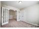 Bedroom with carpet, with French doors leading to what could be used as an office space at 11203 Chapeclane Rd, Charlotte, NC 28278