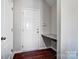 This entryway features a small desk and dark, hardwood flooring at 11203 Chapeclane Rd, Charlotte, NC 28278