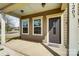 Cozy covered front porch features traditional decor, windows, and a welcoming front door at 11203 Chapeclane Rd, Charlotte, NC 28278