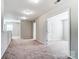 Carpeted hallway with neutral walls and overhead lighting at 11203 Chapeclane Rd, Charlotte, NC 28278