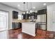This kitchen features granite countertops, a stainless steel refrigerator, and dark cabinets at 11203 Chapeclane Rd, Charlotte, NC 28278