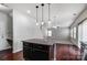 The kitchen island has granite countertops with black cabinets and modern pendant lighting at 11203 Chapeclane Rd, Charlotte, NC 28278