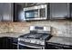 The kitchen backsplash matches the granite countertops and stainless steel appliances at 11203 Chapeclane Rd, Charlotte, NC 28278