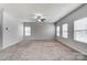 Bright open living room with neutral walls, ceiling fan and carpeting at 11203 Chapeclane Rd, Charlotte, NC 28278