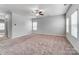 Inviting living room with large windows, neutral walls, and ceiling fan at 11203 Chapeclane Rd, Charlotte, NC 28278