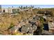 Aerial view showcases an entire neighborhood, surrounded by trees, with the city skyline in the background at 1131 S Kings Dr, Charlotte, NC 28207