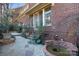 Beautiful brick patio with slate accents, landscaped with lush greenery and a relaxing water feature at 1131 S Kings Dr, Charlotte, NC 28207