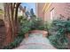 Serene backyard featuring a flagstone patio, brick accents, and lush plantings for a private retreat at 1131 S Kings Dr, Charlotte, NC 28207