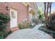 Inviting backyard patio with a brick walkway, complemented by mature trees and manicured landscaping at 1131 S Kings Dr, Charlotte, NC 28207