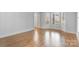 Spacious empty room with hardwood floors, baseboards, and natural lighting at 1131 S Kings Dr, Charlotte, NC 28207