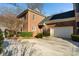 Charming brick home featuring a two-car garage and manicured landscaping at 1131 S Kings Dr, Charlotte, NC 28207