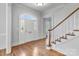 Bright foyer with hardwood floors, staircase, and leaded glass front door at 1131 S Kings Dr, Charlotte, NC 28207