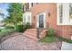 Inviting brick front entrance with black iron railings and a landscaped garden at 1131 S Kings Dr, Charlotte, NC 28207