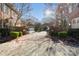 Elegant gated community entrance with lush landscaping and well-maintained brick facade at 1131 S Kings Dr, Charlotte, NC 28207