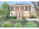 Charming brick two-story home featuring black shutters and manicured landscaping at 1131 S Kings Dr, Charlotte, NC 28207