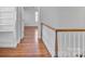 Upstairs hallway with hardwood floors and built in bookshelves at 1131 S Kings Dr, Charlotte, NC 28207