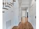 Hallway features hardwood floors and leads past white trimmed entryways at 1131 S Kings Dr, Charlotte, NC 28207