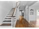 Elegant hallway showcasing hardwood floors, stairway and detailed trim work at 1131 S Kings Dr, Charlotte, NC 28207